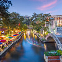 River walk in San Antonio city downtown skyline cityscape of Texas USA at sunset