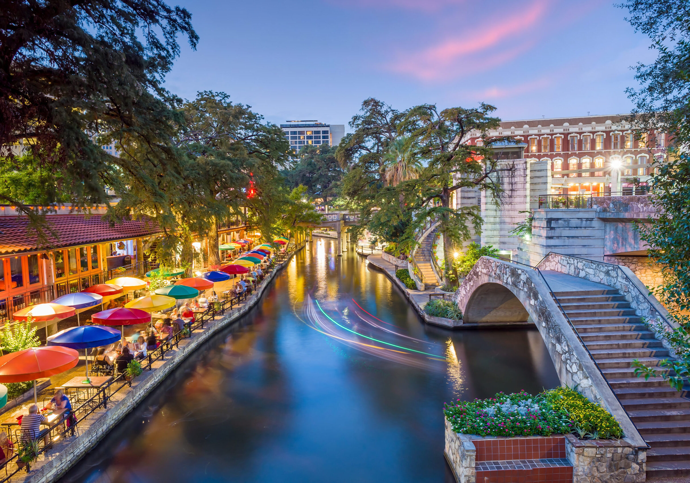 River walk in San Antonio city downtown skyline cityscape of Texas USA at sunset