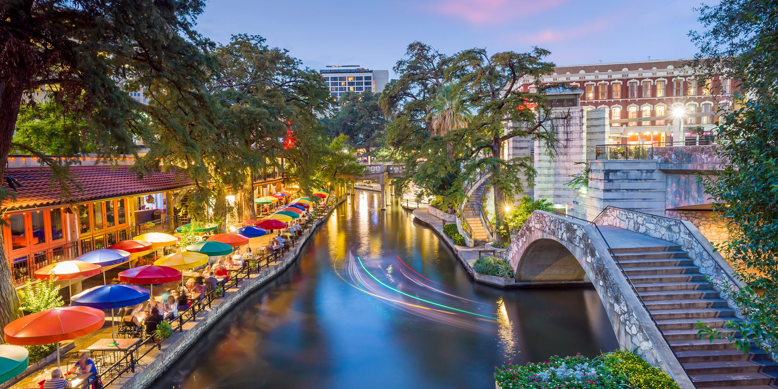 River walk in San Antonio city downtown skyline cityscape of Texas USA at sunset